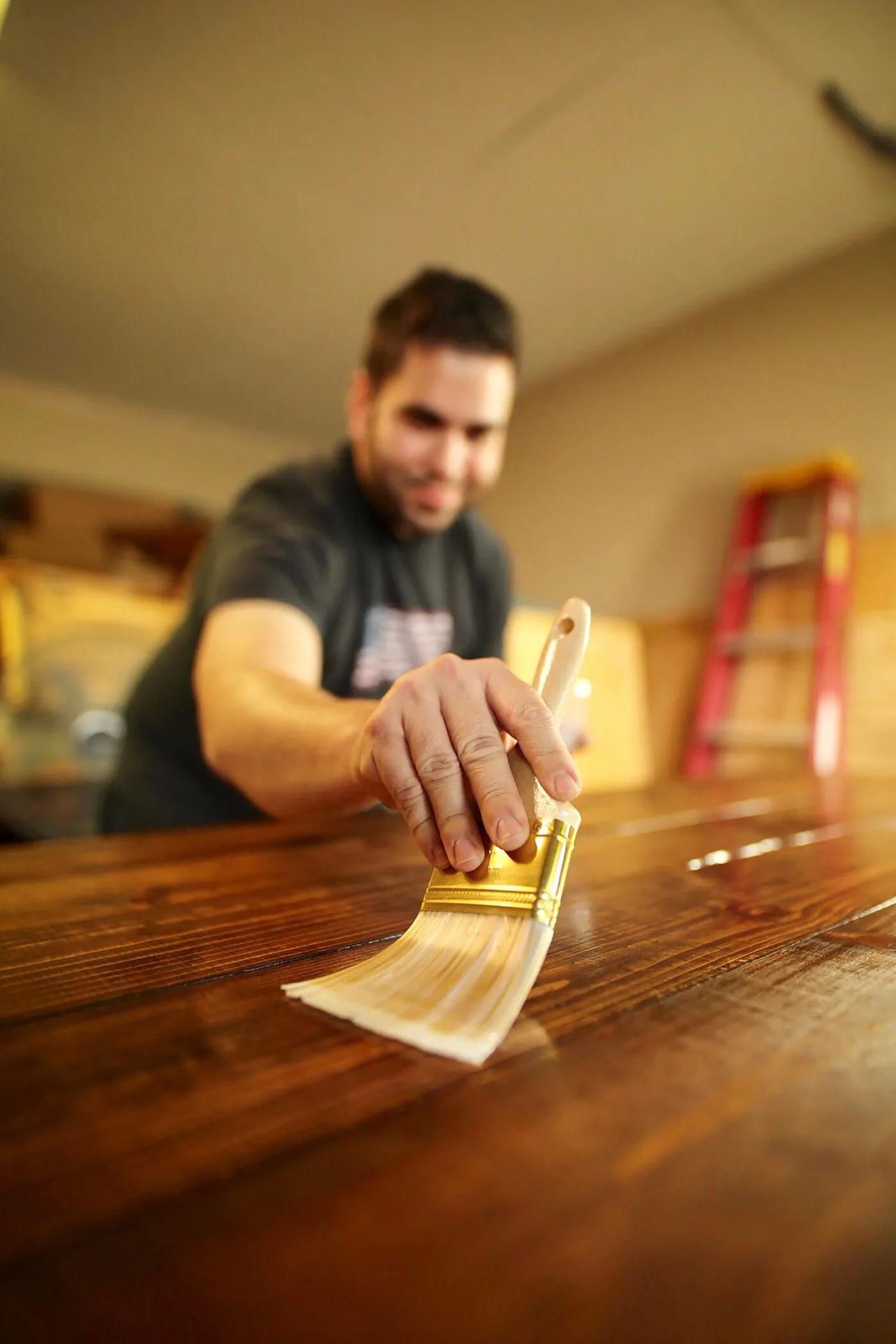 Wood being finished with stain and varnish